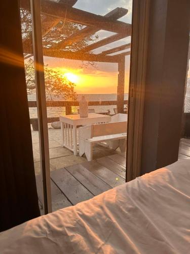 a view of a patio with a table and the sunset at Pio's Place Hidden Resort in Namonitan