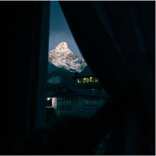 a view of a mountain from a window at Fast food in Lukla