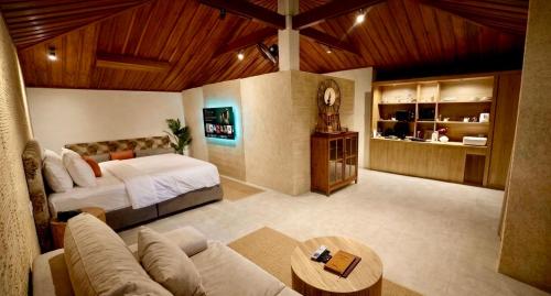 a large room with a bed and a couch at Tulum Villa Resort Koh Samui in Bophut