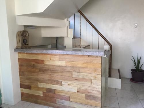 a staircase with wooden floors and a stair case at 1 River Central Hostel in Manila