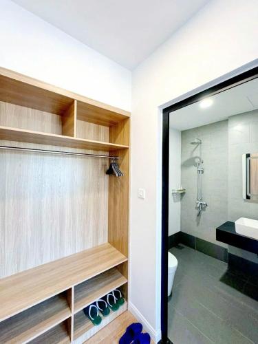 a bathroom with a toilet and a sink and a mirror at Ruby Homestay in Cam Lâm