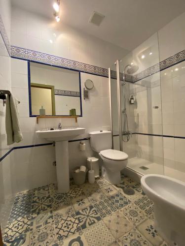 a bathroom with a sink and a toilet and a shower at La Ventera - Casa Rural in Gualchos