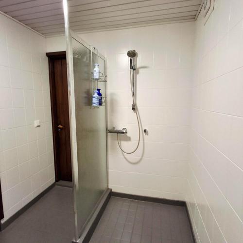 a shower with a glass door in a bathroom at Nordic City Home in Lahti