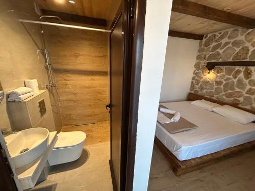 a bathroom with a bed and a shower and a toilet at Medo in Ulcinj