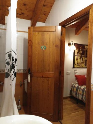 a bathroom with a wooden door in a room at Residencial Valle de Benasque in Benasque
