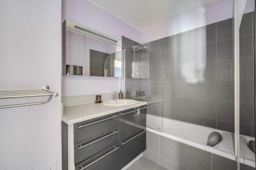 a bathroom with a sink and a shower at Spacious Studio 2P - Near La Défense in Courbevoie