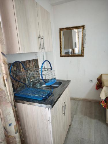 a kitchen with a sink and a mirror on the counter at VillA SIMO in Kočani