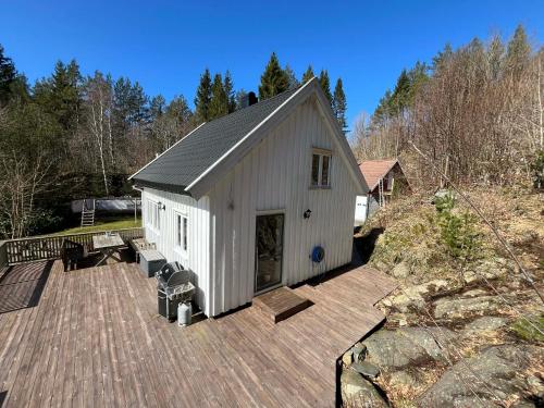 a large white building with a deck at Snemyr i Høvåg in Høvåg