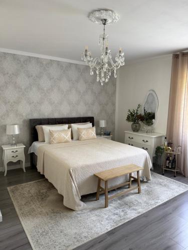 a bedroom with a large bed and a chandelier at Rooms Zana in Split
