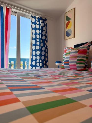 a bedroom with a bed with a view of the ocean at Le logis de l estuaire in Meschers-sur-Gironde