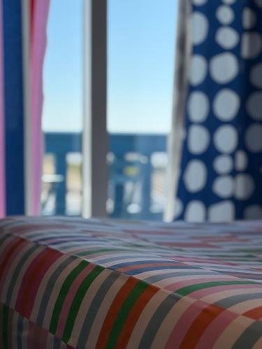 a close up of a striped couch in a room at Le logis de l estuaire in Meschers-sur-Gironde