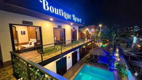 a hotel with a swimming pool in front of a building at Mi Lan Boutique Resort in Vung Tau