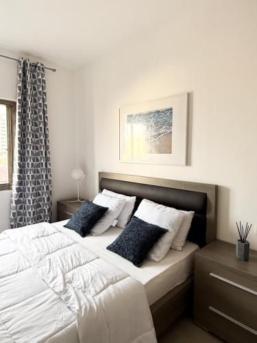 a bedroom with a large white bed with pillows at Résidence Uria in Libreville