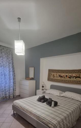 a bedroom with a bed with two teddy bears on it at The happy smile villa in Bella Farnia