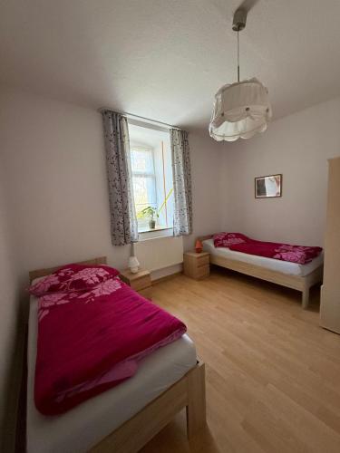 a bedroom with two beds and a window at Fewo zum Klosterhof EG 1 in Schwanebeck