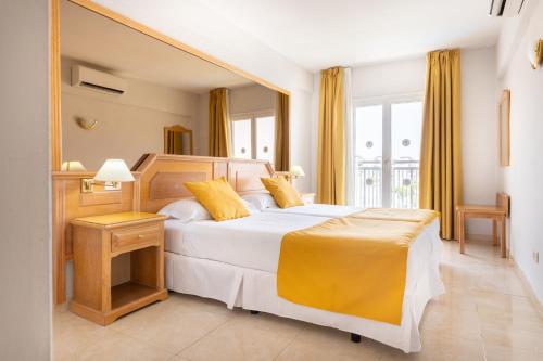 a bedroom with a large bed with yellow pillows at Villa De Adeje Beach in Adeje