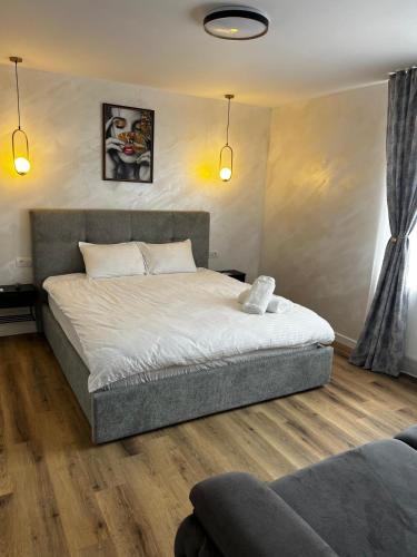 a bedroom with a bed and a couch at 7 min walking to airport in Otopeni