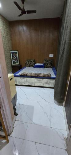 a bedroom with a bed and a ceiling fan at Home stays 1bhk in Jammu