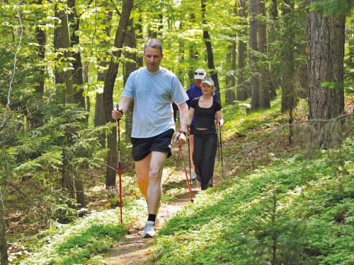 a man and woman walking on a trail in the woods at RETTER Bio-Natur-Resort in Pöllauberg