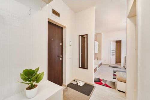 a room with a hallway with a door and a plant at Princess Cozy Home Casy in Timişoara