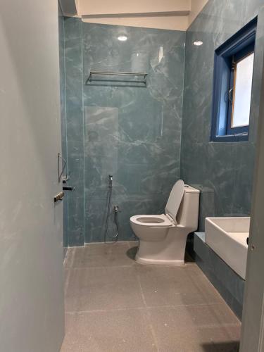 a bathroom with a toilet and a tub and a sink at E-RE House, Dirang in Dirang Dzong