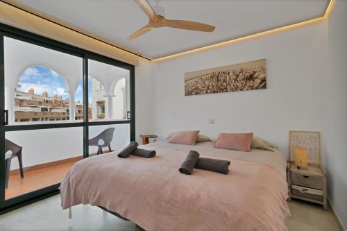 a bedroom with a large bed and a large window at Casa Mar & Golf in San Luis de Sabinillas