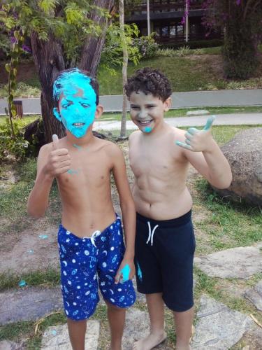 two young boys with blue paint on their faces at Flat studio monte castelo gravatá PE in Bezerros