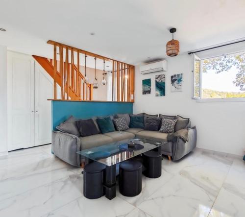 a living room with a couch and a table at Maison de campagne in Tourrettes
