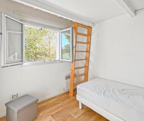 a bedroom with a bunk bed and a ladder at Maison de campagne in Tourrettes