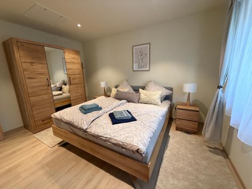 a bedroom with a bed with two towels on it at Ferienhaus Senzig Waldesruh in Königs Wusterhausen