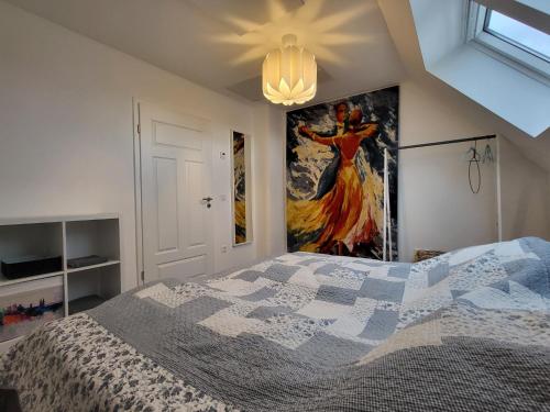a bedroom with a bed and a painting on the wall at Leichlingen 1 in Leichlingen