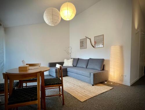 a living room with a couch and a table at LAne Têtu in Désaignes