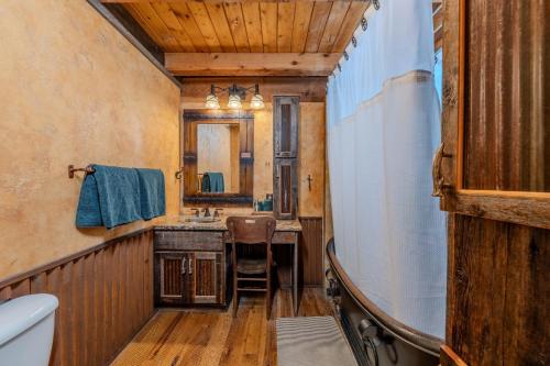 a bathroom with a sink and a mirror at 20 mins to YNP-Cabin-Pet friendly in Island Park