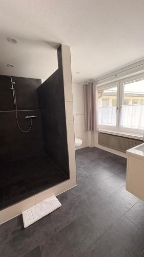 a bathroom with a large shower and a sink at Gasthof Söll in Niedertaufkirchen