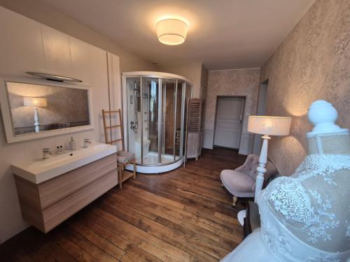 a bathroom with a bed and a sink and a shower at La Bâtisse de Bromont in Bromont-Lamothe