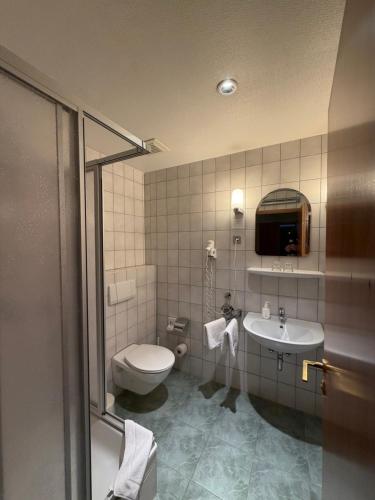 a bathroom with a toilet and a sink at Hotel Liszt in Weimar