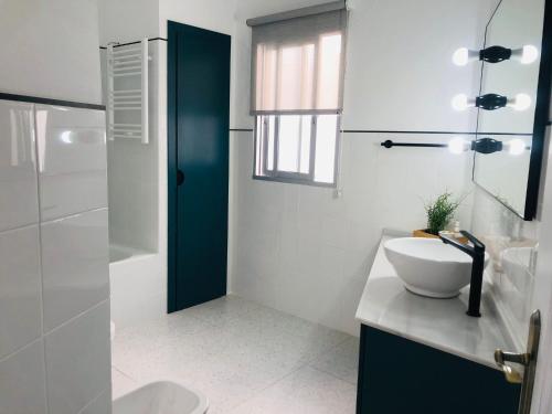 a bathroom with a sink and a toilet and a shower at La casa grande 2 in Carmona