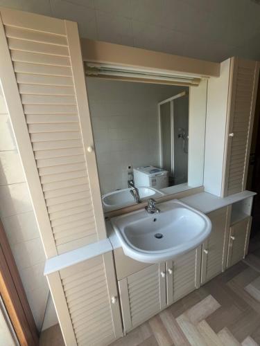a bathroom with a sink and a mirror at La dolce vela in Muggia