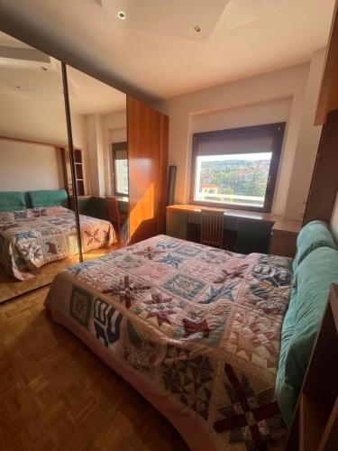 a bedroom with two beds and a large window at La dolce vela in Muggia