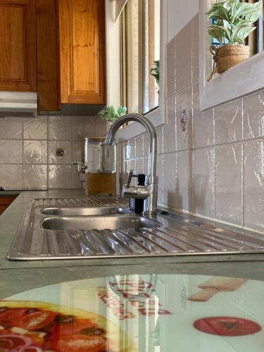 a kitchen sink with a faucet on a counter at Family Haven Bradburry in Campbelltown South
