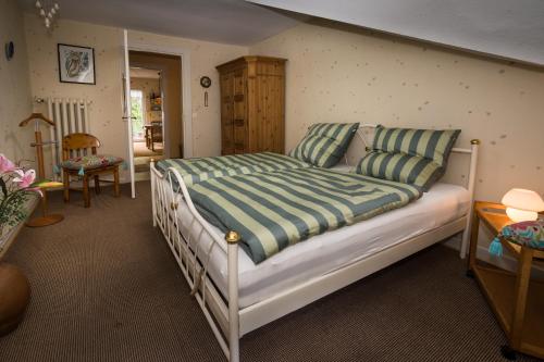a bedroom with a large bed with striped pillows at Villa Robert Heuser in Traben-Trarbach
