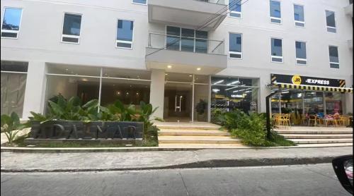 a building with black chairs in front of a building at Apartamento Adalmar 201 in San Andrés