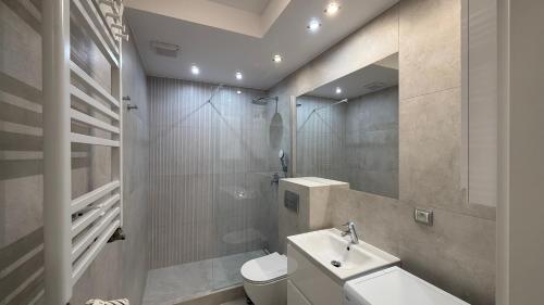 a bathroom with a toilet and a sink at Aqua Villa 4 in Jurata