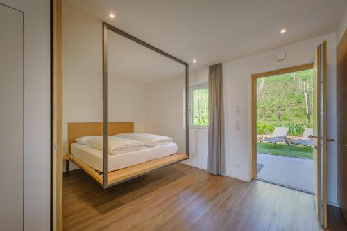 a bedroom with a bed with a large mirror at Tholr - Ferienwohnungen - Tramin in Termeno