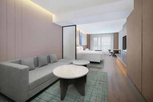 a living room with a couch and a table at Fairfield by Marriott Changchun Chaoyang in Changchun