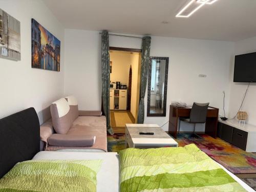 a living room with a couch and a table at City Ferienwohnung Bayreuth in Bayreuth