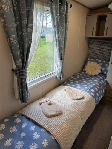 a small bedroom with a bed and a window at Tattershall Lakes 49 Larch View in Tattershall