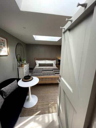 a bedroom with a bed and a white door at Studio 77 Cheltenham in Cheltenham