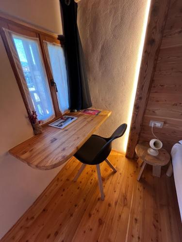 a desk in a room with a chair and a window at L'Antico Piol de Feltre in Feltre