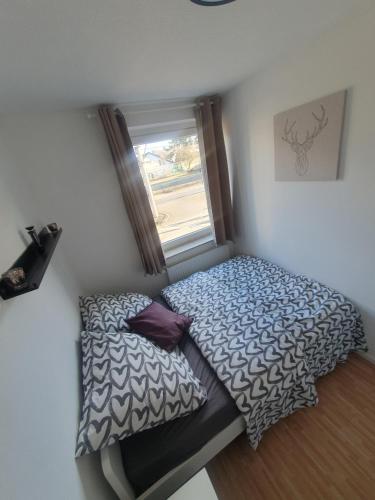 a small bedroom with a bed and a window at Angenehmes privatzimmer in Cologne